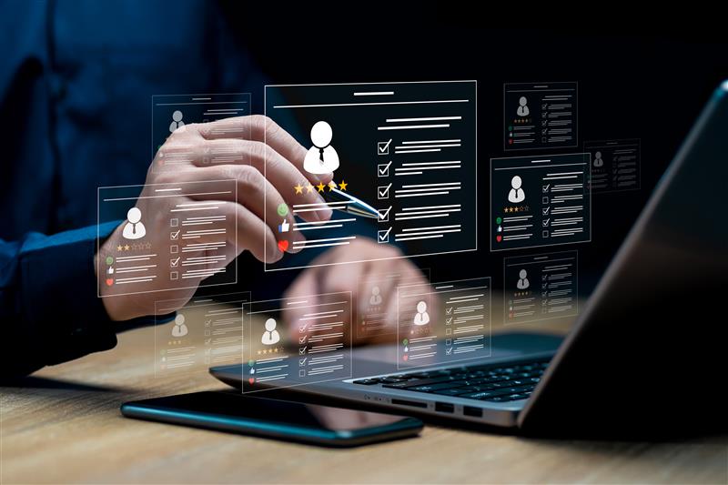 Hand interacting with virtual interface showing multiple digital profiles and checklists on a laptop screen.